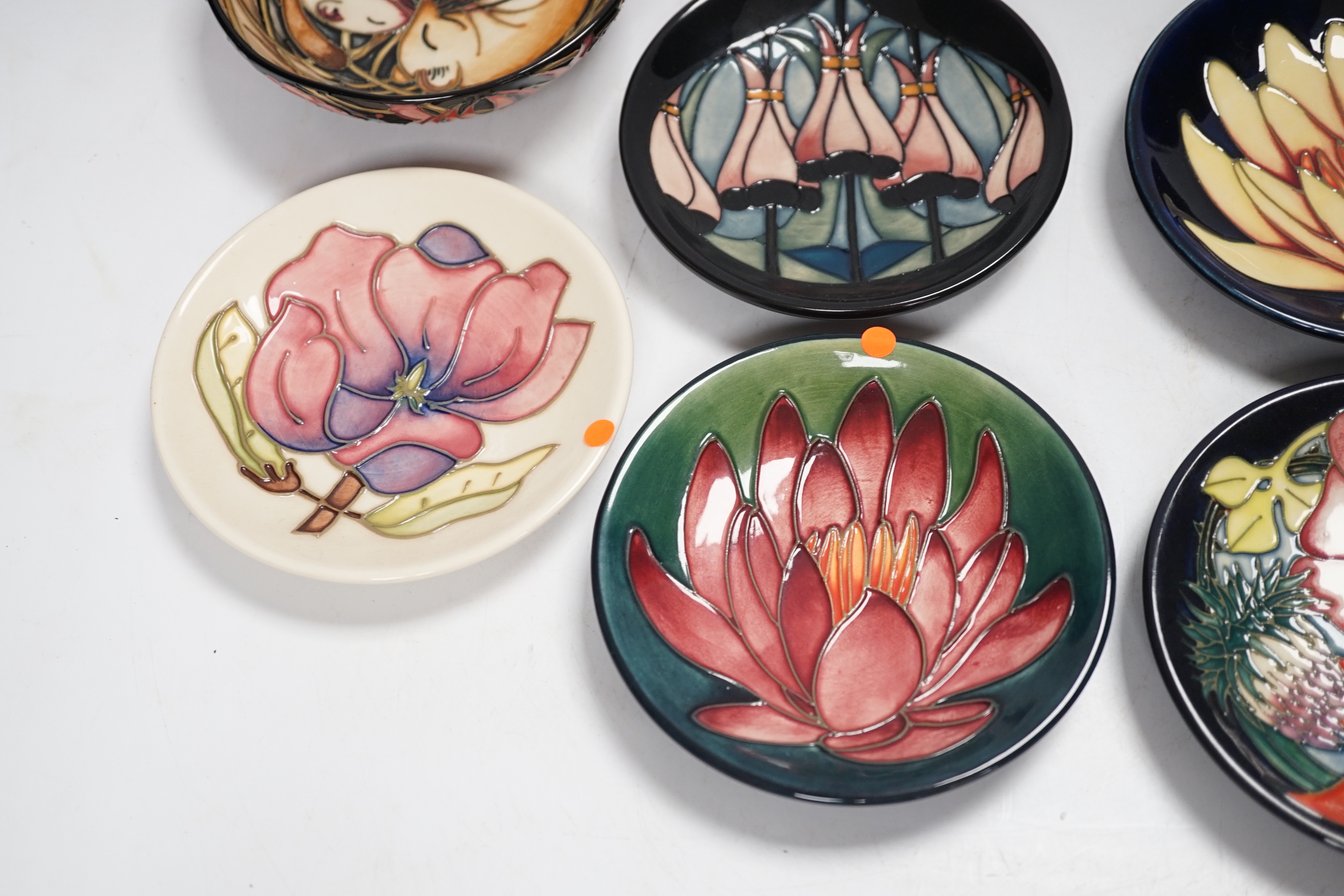 Seven Moorcroft floral dishes, two with Kerry Goodwin stamp to the base and a dormouse bowl designed by Emma Bossons, limited edition 14/100, 12cm in diameter